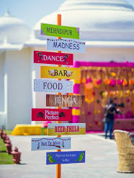 Wedding Signage And Prop Ideas We Re Loving Right Now Mehndi Decor Indian Wedding Theme Desi Wedding Decor