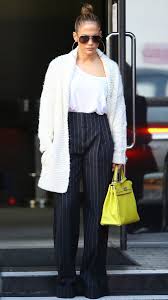 Black And White Striped Wide Leg Pants Outfit Jennifer Lopez In A White Top Cardigan And High Waisted Black Pants Wide Leg Pants Outfit Stripe Pants Outfit White Flare Pants