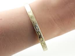 The engraving could be darker. Luxurious Art Deco Engraved Green Gold Bangle