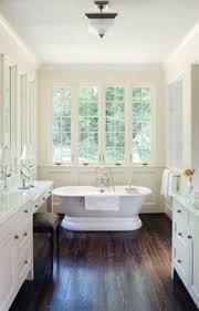 Give your bathroom a strong and stylish foundation. Such A Great Bathroom Dark Wood Floors Anchor White Walls And Cabinets While The Freestanding Ba Wood Floor Bathroom Bathrooms Remodel Living Room Wood Floor
