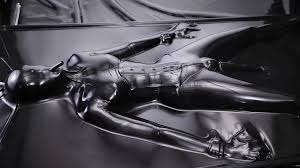 Bound in a latex vac bed