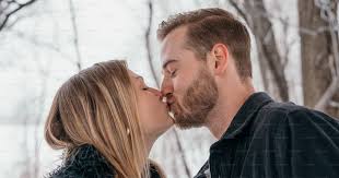 A man and a woman kissing in the snow photo