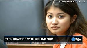 Teen charged with stabbing mom stares into camera