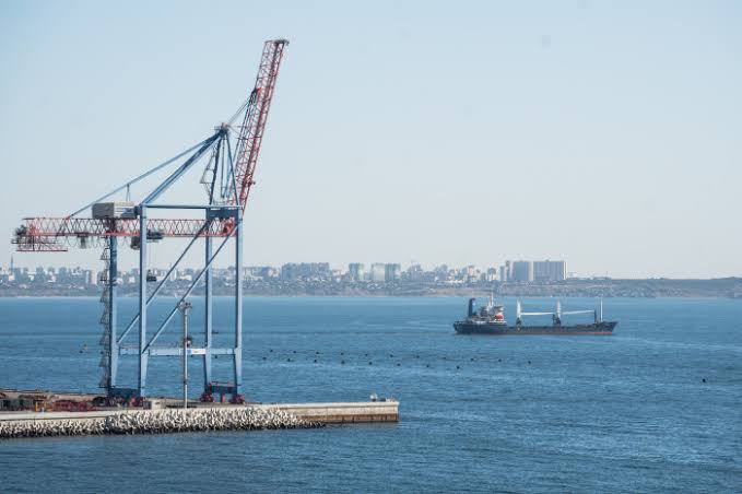 A view of Ukrainian grain silos and docked cargo ships at a Black Sea port, highlighting the impact of the ongoing maritime blockade.