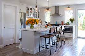 White and gray kitchen features white cabinets adorned with bronze cup pulls and. Simply White Kitchen With Light Grey Island Crystal Cabinets