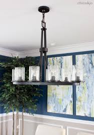 The silver wallpaper with a classic pattern gives a uniquely modern and vintage nuance to the decor of this living room. Transitional Dining Room Makeover Chica And Jo