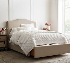 This tailoring detail is also carried over to the boxing on seat and back cushions. Raleigh Curved Upholstered Low Footboard Storage Platform Bed Pottery Barn