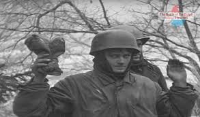 The Battle - HARLANGE, LUXEMBOURG - A captured German paratrooper from  Generalmajor Ludwig Heilmann's 5th Fallschirmjäger-Division gives a grim  glance at the camera for the photographer, a member of the US 166th