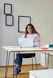 Home office ideas for women that need rest too. Young Professional Woman Working At A Desk In Her Home Office By W2 Photography Working Portrait Stocksy United