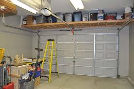 Above Garage Door Storage Solutions In 2020 Garage Storage Shelves Garage Ceiling Storage Overhead Garage Storage