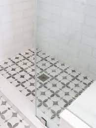 Cultured marble, onyx, and granite thresholds offer a durable, and easy to clean alternative to natural stone or tile thresholds. White Marble Shower Threshold Highlights White And Gray Quatrefoil Floor Tiles In A Walk In Shower Enclosed By Shower Floor Tile Shower Floor Shower Threshold