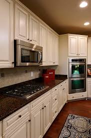 Of course, depending on your options, white cabinets often represent modern designs. Top 10 Best White Bright Kitchen Design Ideas Pouted Com Antique White Kitchen Brown Granite Countertops Antique White Kitchen Cabinets