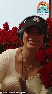 Nick Cannon surprises one of his six baby mamas Abby De La Rosa with 3000  red roses during their radio show... months after welcoming 12th child
