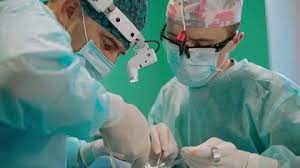 Professional Doctors Doing A Surgery Faces Of Surgeons With Medical Light Ad Surgery Doctors Faces Professional Business Cards Diy Templates Doctor Surgery