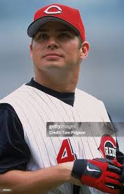 A close up of Brandon Larson of the Cincinnati Reds as he looks on... News  Photo