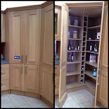 A corner pantry with an angled door maximizes storage space in the kitchen. Walk In Corner Pantry With Wine Rack And Automatic Led Lights Corner Pantry Kitchen Corner Cupboard Kitchen Pantry Design