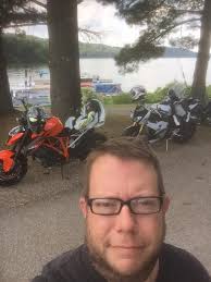 Surrounded by a group of young motorcyclists at a red light