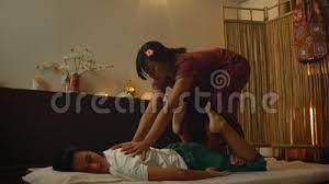 Alternative Chinese Medicine, an Asian Woman Performs Therapeutic Massage  Movements on the Back and Legs of a Caucasian Stock Footage - Video of  manual, physical: 165983586