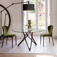 In this setting, the intricately designed cloth between the table and glass add more depth to the design. Contemporary Dining Table Circe Porada Tempered Glass Walnut Base Round