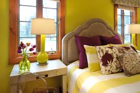 Welcoming yellow and gray bedroom boasts a yellow channel tufted bed dressed in yellow bedding accented with yellow and gray pillows placed beneath a yellow and gray pleated valance finished with yellow and gray curtains. Yellow And Purple Bedroom Houzz