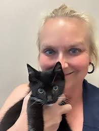 Woman cares for multiple cats and kittens