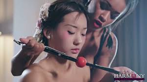 Two lesbians make use of ball gag and strapon to punish Chinese babe Alina  Li