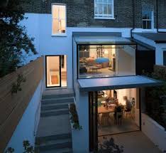 A Double Height Glassextension To The Rear Of This London Home Connected The Upper And Lower Ground Floor Living Timber House Glass Extension House Extensions