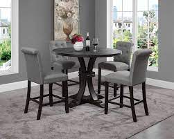 This gorgeous counter height dining table features an elegant round tabletop and pedestal base, lending a midcentury modern vibe. Siena Distressed Black Finish 5 Piece Counter Height Dining Set Pedestal Round Table With Gray Chairs Walmart Com Walmart Com