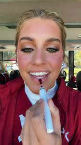 Alabama Cheerleader Standing Next to Volleyball Player