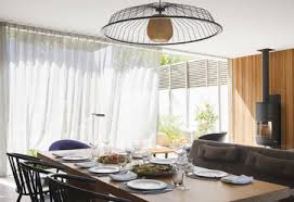A crystal chandelier is usually considered more traditional, while iron can have an industrial edge. Chandelier Over Dining Table In Modern Dining Room Stockphoto
