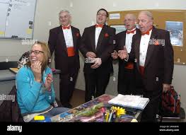 King's College student Pauline Foley, left, reacts as she is serenaded by  the Harmony Notes Valentine Barbershop Quartet in her classroom at King's  College, Wilkes-Barre, Pa., Tuesday, Feb. 14, 2012. The quartet