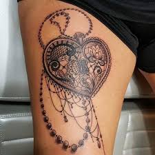 This lace tattoo design is elegant and unique, and the lotus in the center is a nice addition to the overall design. Lace Tattoo Locket Tattoos Sleeve Tattoos For Women