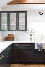 The transitional kitchen's masterpiece is the gorgeous hood with a great island! White Kitchen Cabinets With Black Hardware And Hinges Novocom Top