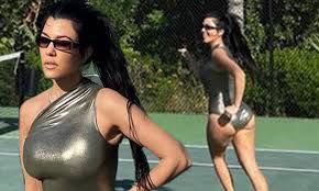 Travis shared kourtney's announcement on his instagram stories and commented with a black heart emoji underneath the post. Kourtney Kardashian Turns Heads As She Takes To The Tennis Court In A Shiny Gold Swimsuit Daily Mail Online