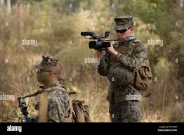 U.S. Marine Corporal Eric Moreno, a combat cameraman for the School of  Infantry-East (SOI-E) films Marines with Delta Company, Infantry Training  Battalion, SOI-E receiving a combat order brief before stepping off on