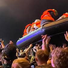 Banksy launches inflatable migrant boat artwork during Idles' Glastonbury  set | Glastonbury 2024 | The Guardian