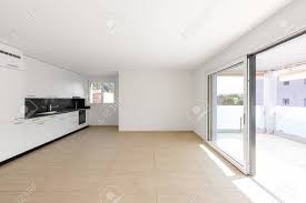 empty room with white walls, travertine