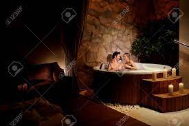 The jacuzzi has more modified pumps to work through pumping petals through jets. A Loving Couple With A Glass Of Champagne In A Jacuzzi With Candles Stock Photo Picture And Royalty Free Image Image 94380001