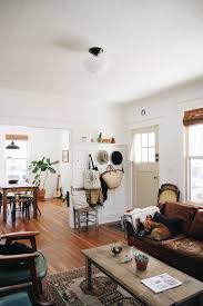 Mid Century Modern Living Room Dining Room White Walls With Wooden Floors Persian Rugs Leather Brown Couches And Plants Home Home Living Room Home Decor