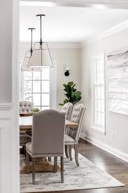 The informal dining room is more of a functional area than a formal dining room. White Dining Room Scene Large Pendants Above Dining Table Jkath Design Build Reinvent Live In Elegant Dining Room Dining Room Decor Informal Dining Rooms