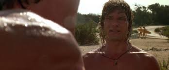 In the middle of point break, there is an extended chase on foot involving keanu reeves chasing patrick swayze while the latter wears a ronald reagan mask. Point Break 1991