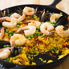 Saffron Infused Paella Is A Popular Spanish Rice And Seafood Dish That 39 S Packed With Flavor But Unusual Ingredients And C Cast Iron Recipes Recipes Paella