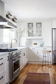 White And Gray Mosaic Kitchen Accent Tiles Are Surrounded By White Shaker Cabinetry Mismatched Refacing Kitchen Cabinets White Shaker Cabinets Kitchen Cabinets