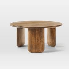 Featuring a large round table top finished with a high gloss piano finish and four tapered legs made of solid wood, this table is built for longevity and easy maintenance while also being perfect to exhibit your favorite collectibles. Round Solid Wood Coffee Table Cre8 Nyc