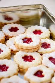With a finger, make an indention in each cookie, fill the indention up with jam using a teaspoon or a pastry bag. Vegan Linzer Cookies Vegan On Board