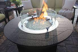 A low wall protects the area from wind, guards it from view, creates a backdrop, and can even double as patio furniture. Round Glass Wind Guard Fire Pit Seating Area Fire Pit Backyard Fire Pit Seating