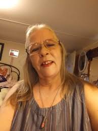 This is my mother that just recently passed away can anyone help me make  her look like a angel please you can edit background whatever you like I  would just really love