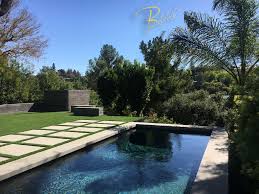 hillside pool w poured in place modern dark grey board form exterior wall texture coping poured in place 2 topcast fi pool plaster pool pool houses