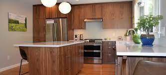 Traditional framed wood cabinets continue to be popular. Contemporary Walnut Kitchen Simpson Cabinetry