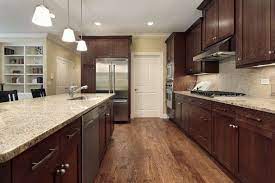 What colors make a small room look bigger? Dark Kitchen Cabinets Look Absolutely Stunning Get Some Great Ideas And View Our Pictur Brown Kitchen Cabinets Walnut Kitchen Cabinets Kitchen Cabinet Design